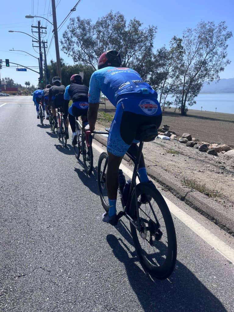 Group photo of iSpeed riders in single file on road