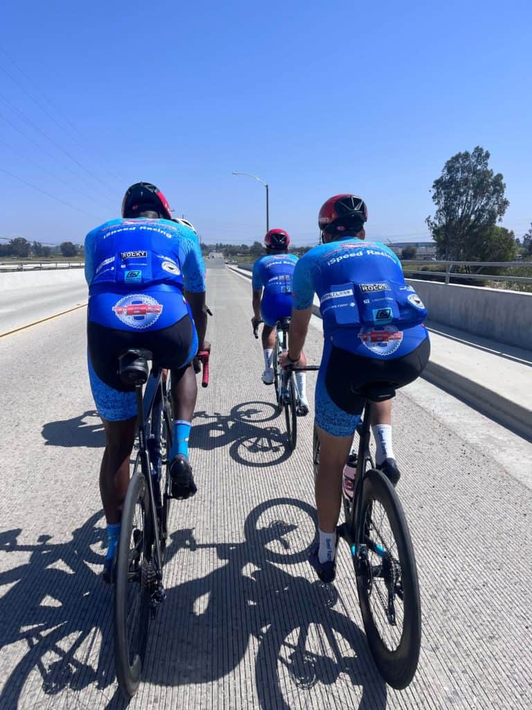 4 iSpeed Racing cyclists riding in pairs on street