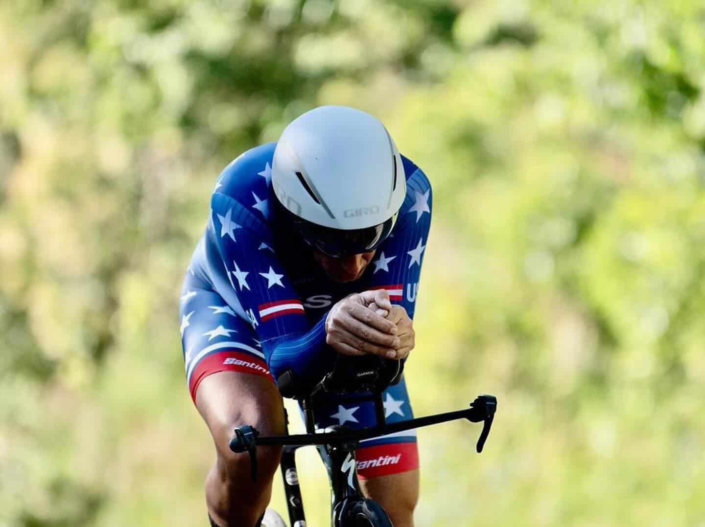 Gil wearing USA jersey on bike in race position