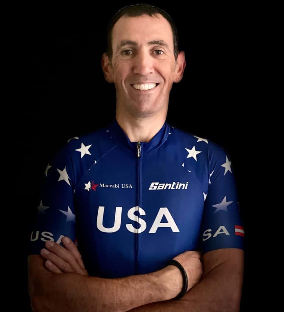 Gil Ron profile photo with arms crossed wearing USA Jersey