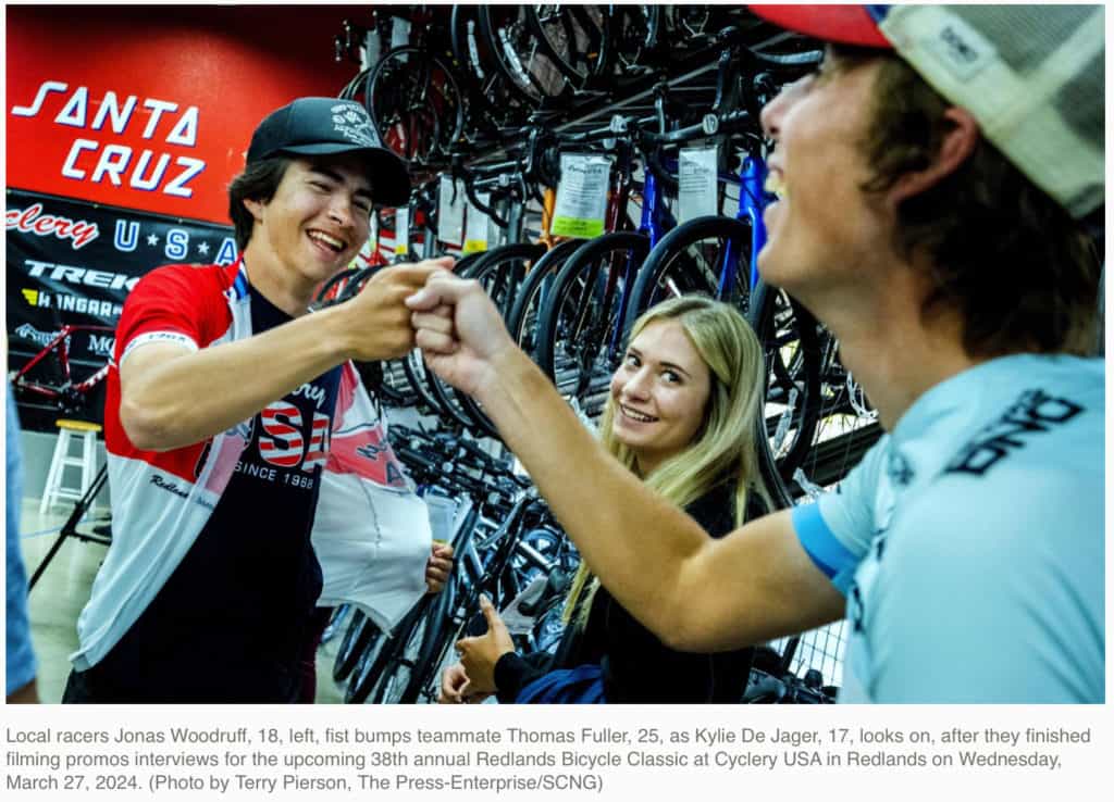 Thomas Fuller and Jonas Woodruff fist pumping after they finished filming promo interviews at Cyclery USA in Redlands.